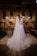 A bride getting ready in a sunlit room, surrounded by her bridesmaids and elegant decor.