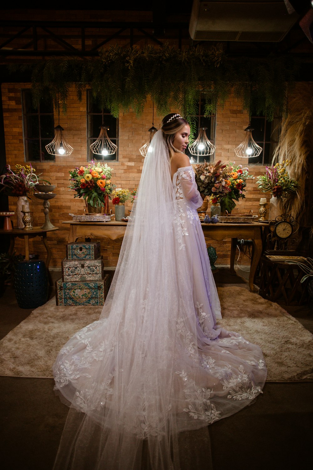 a woman in a wedding dress standing in a room