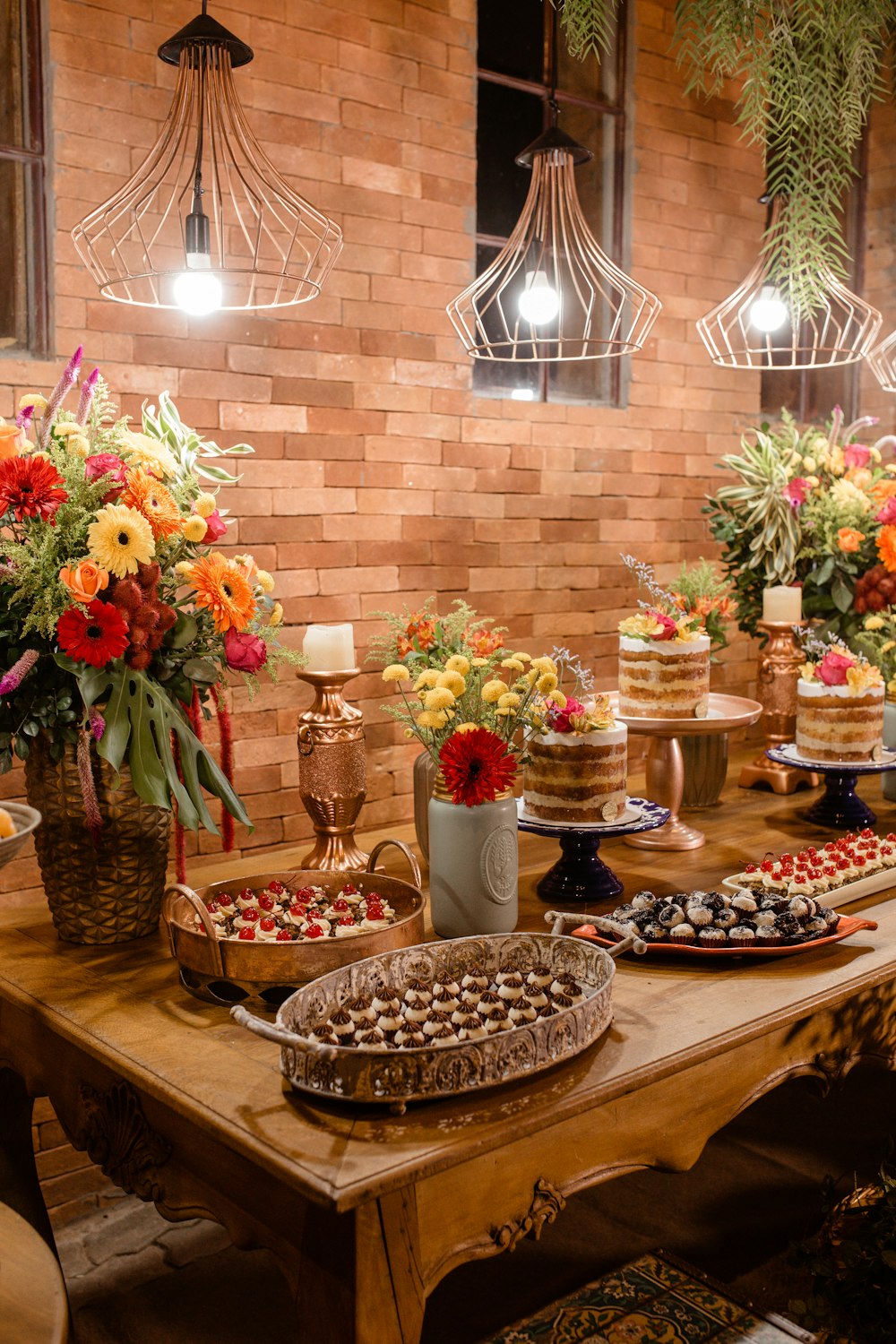 a wooden table topped with lots of desserts