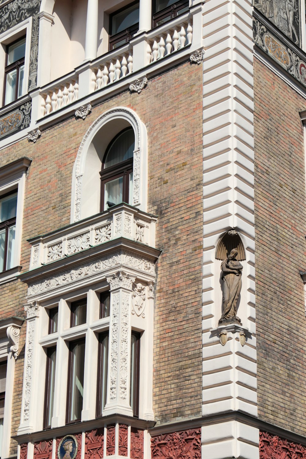 a tall brick building with a clock on it's side