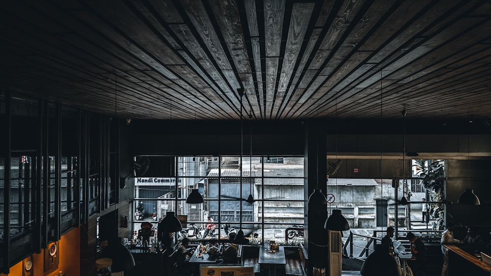 a group of people sitting at a table in front of a window