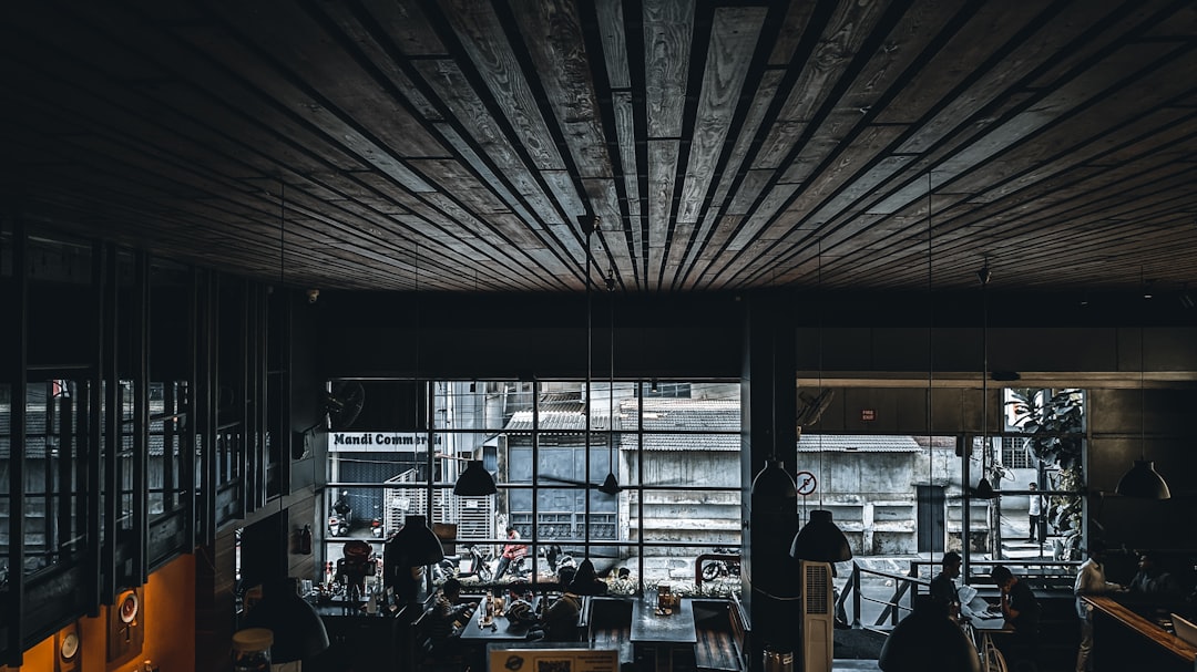 a group of people sitting at a table in front of a window, Truffles - Koramangala