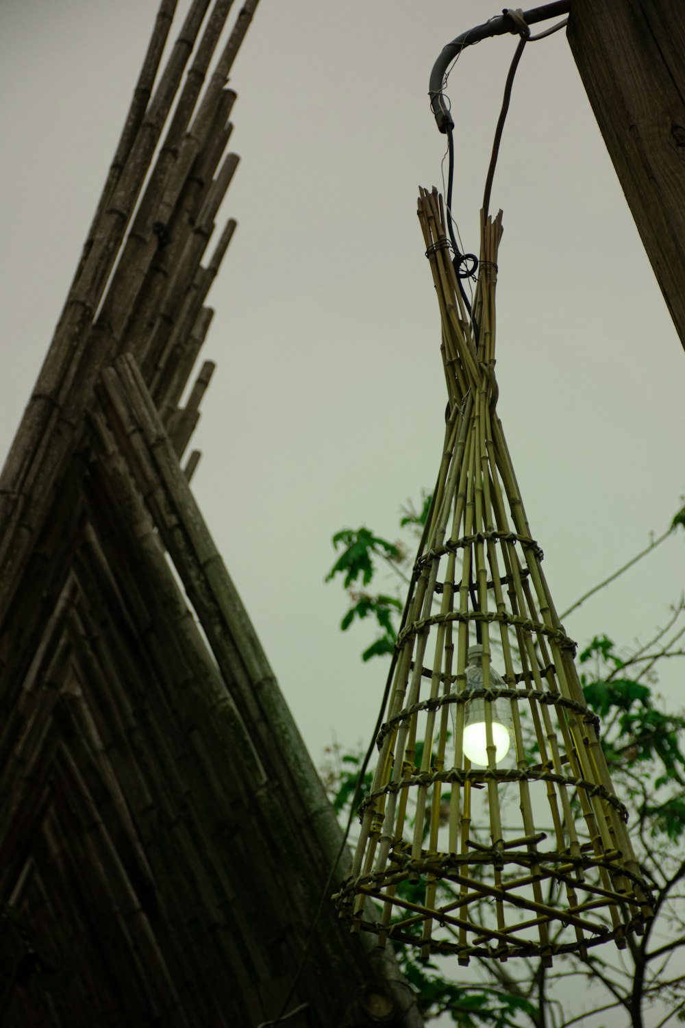 a close up of a bamboo basket hanging from a pole