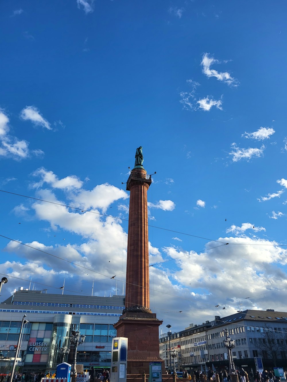 a tall tower with a statue on top of it