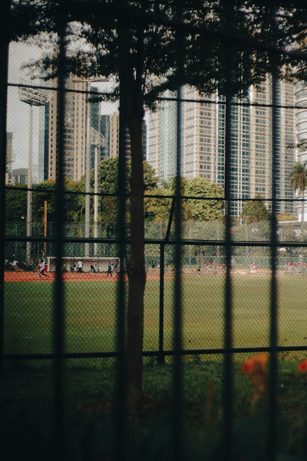 a view of a baseball field through a fence