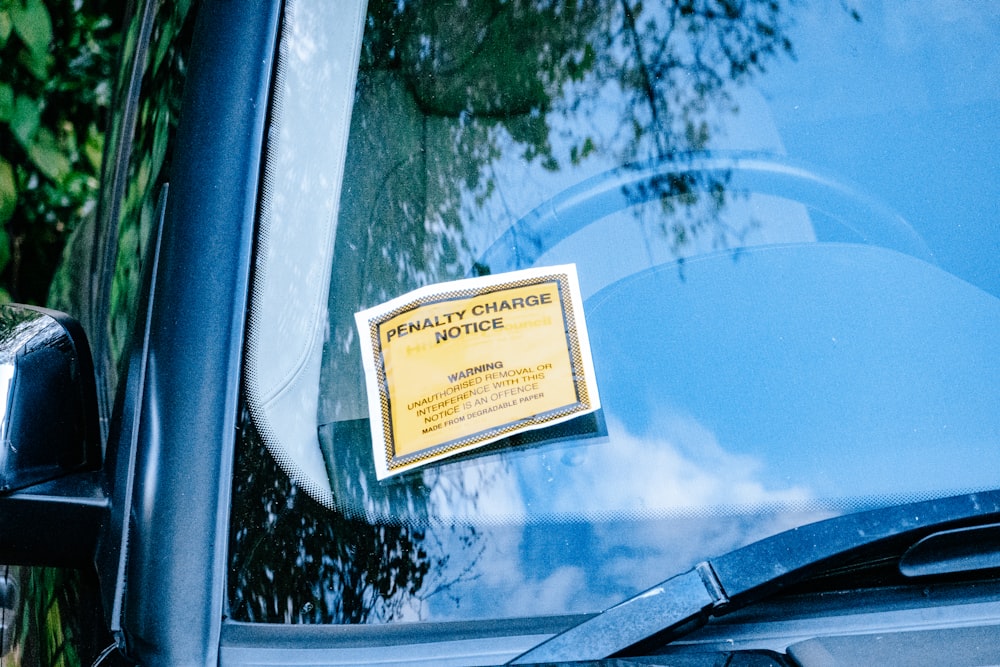 a car with a yellow sign attached to it's side window