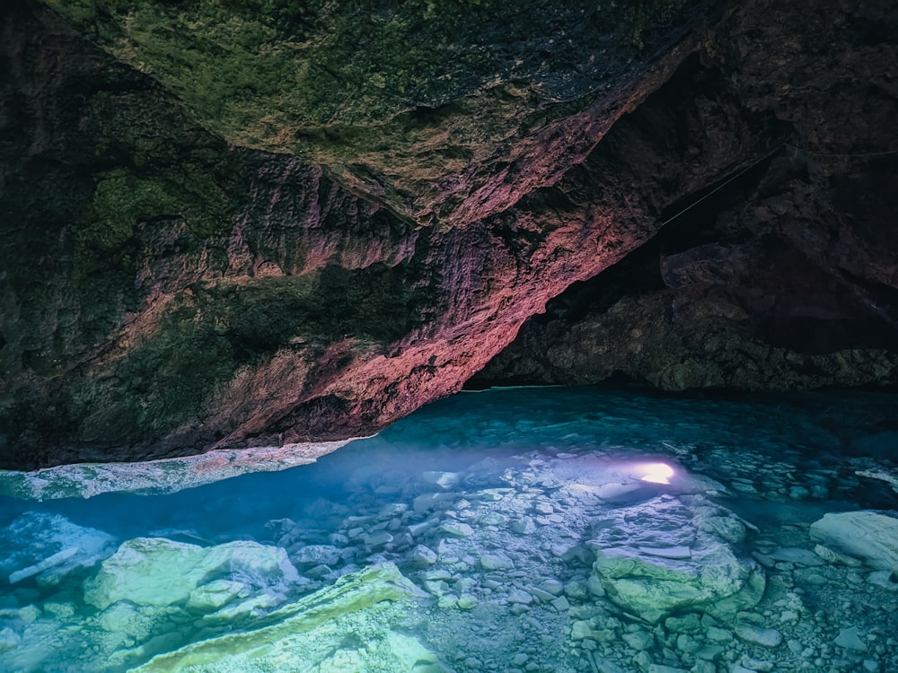 a cave with a pool of water inside of it