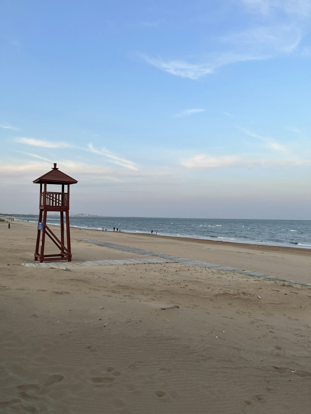 a lifeguard tower sitting on top of a sandy beach