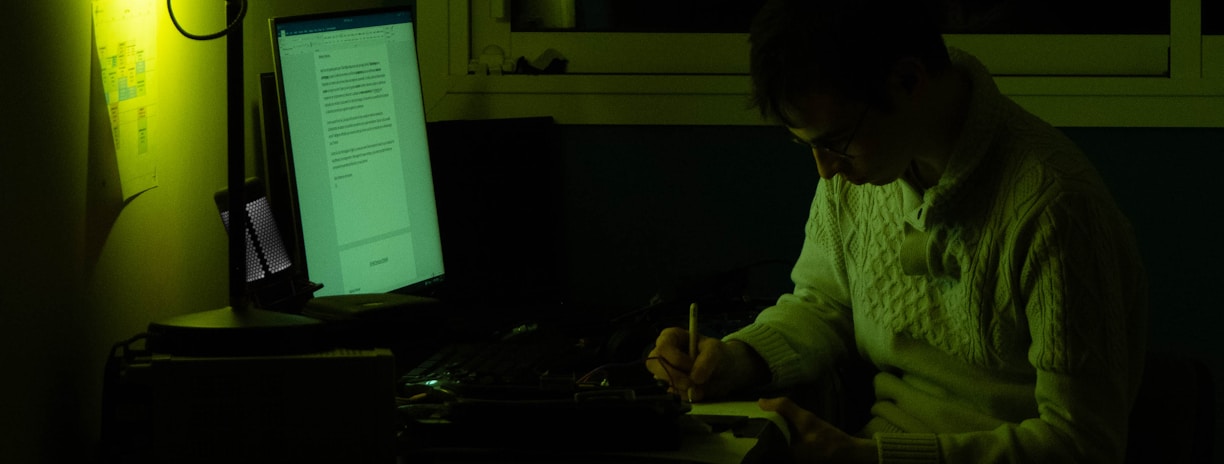 a man sitting in front of a laptop computer