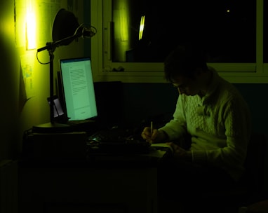 a man sitting in front of a laptop computer