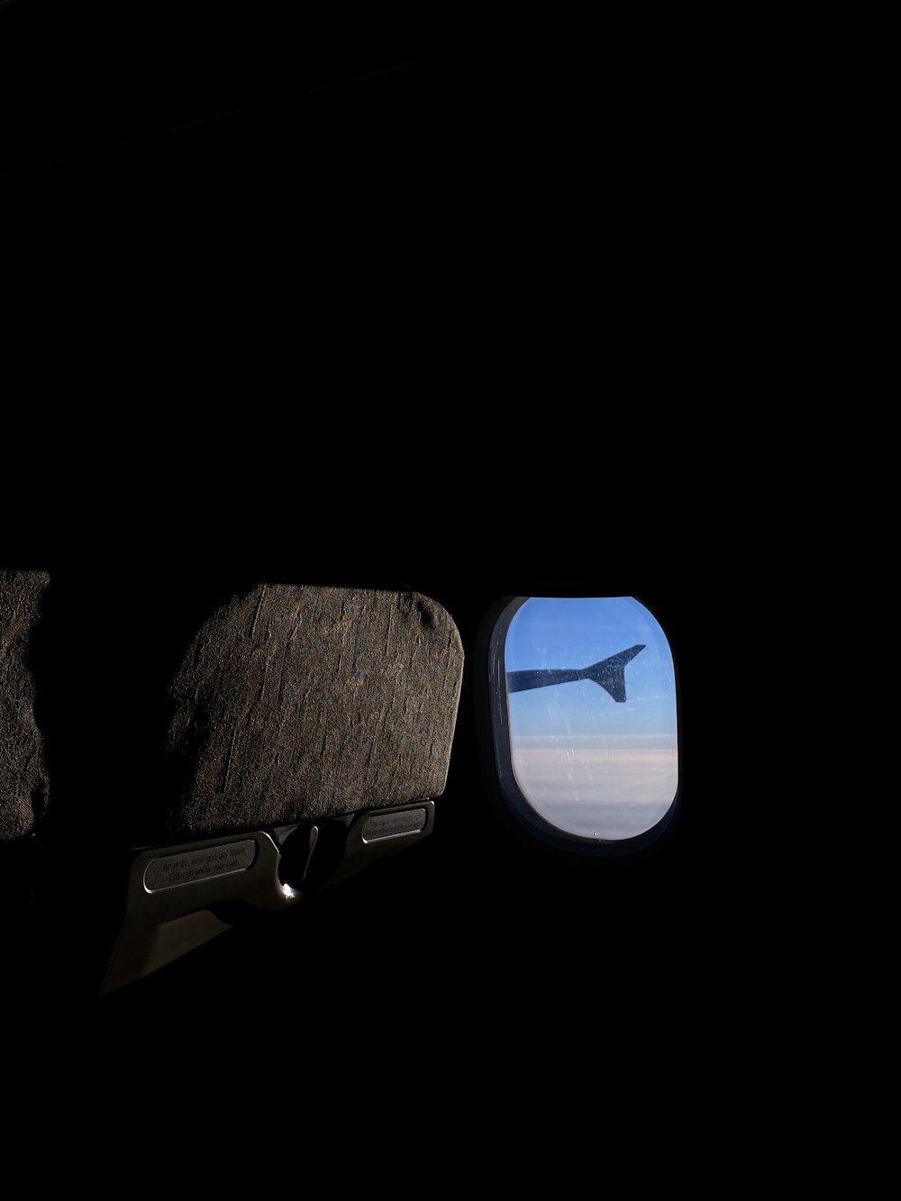 a view of the wing of an airplane through a window