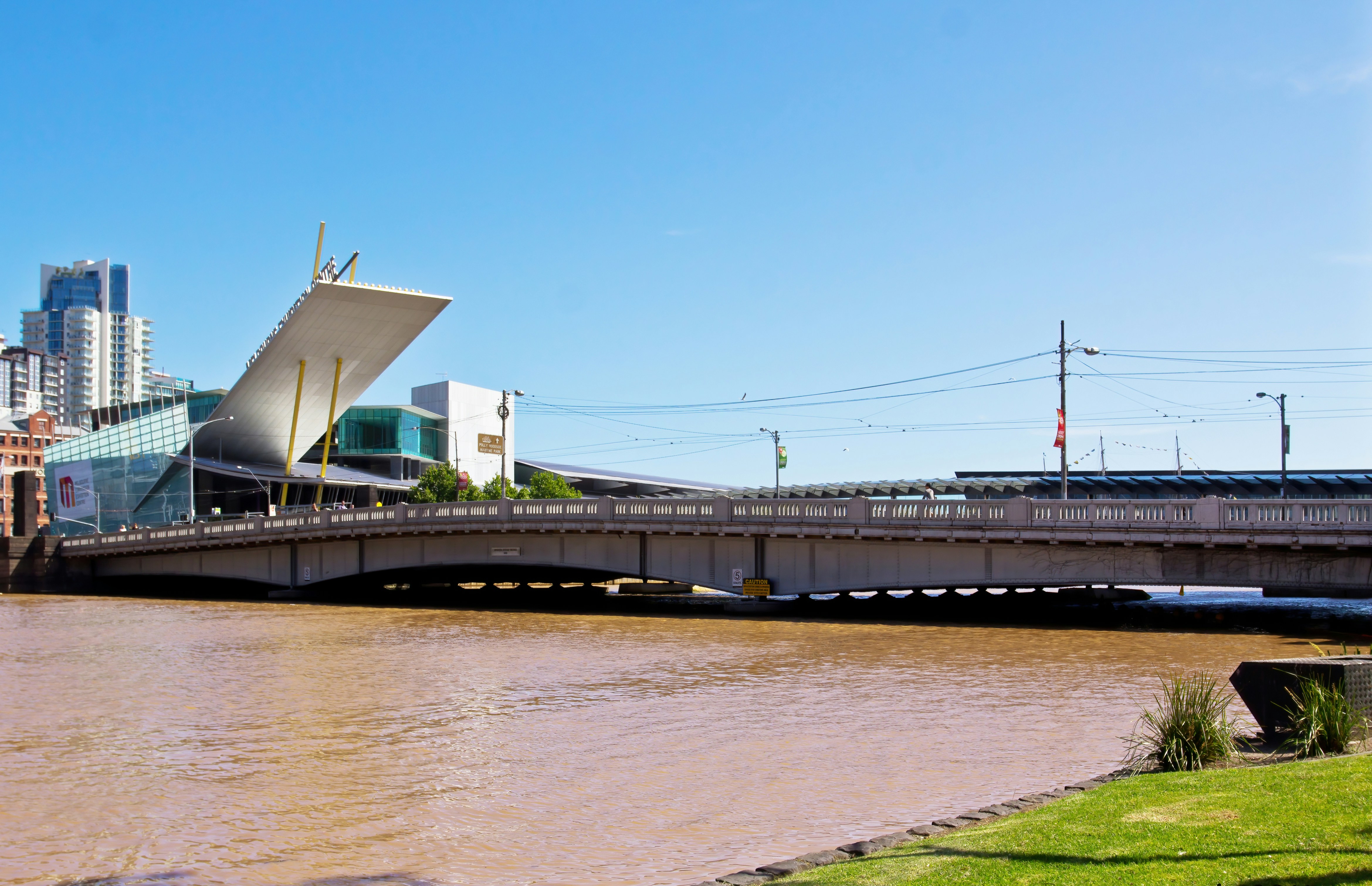 a bridge over a body of water with buildings in the background