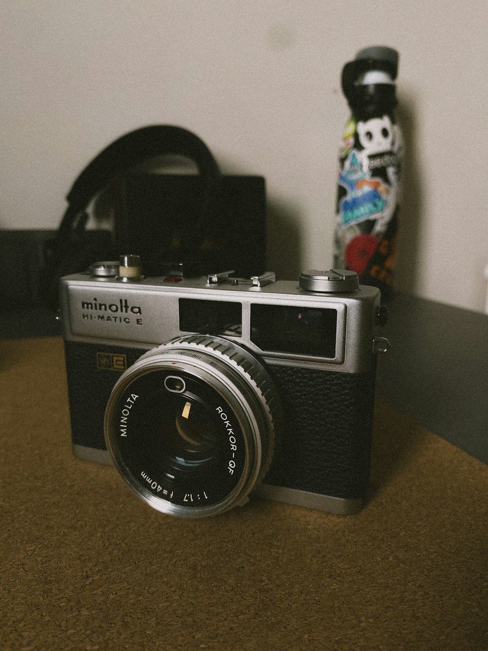 a camera sitting on top of a table next to a skateboard