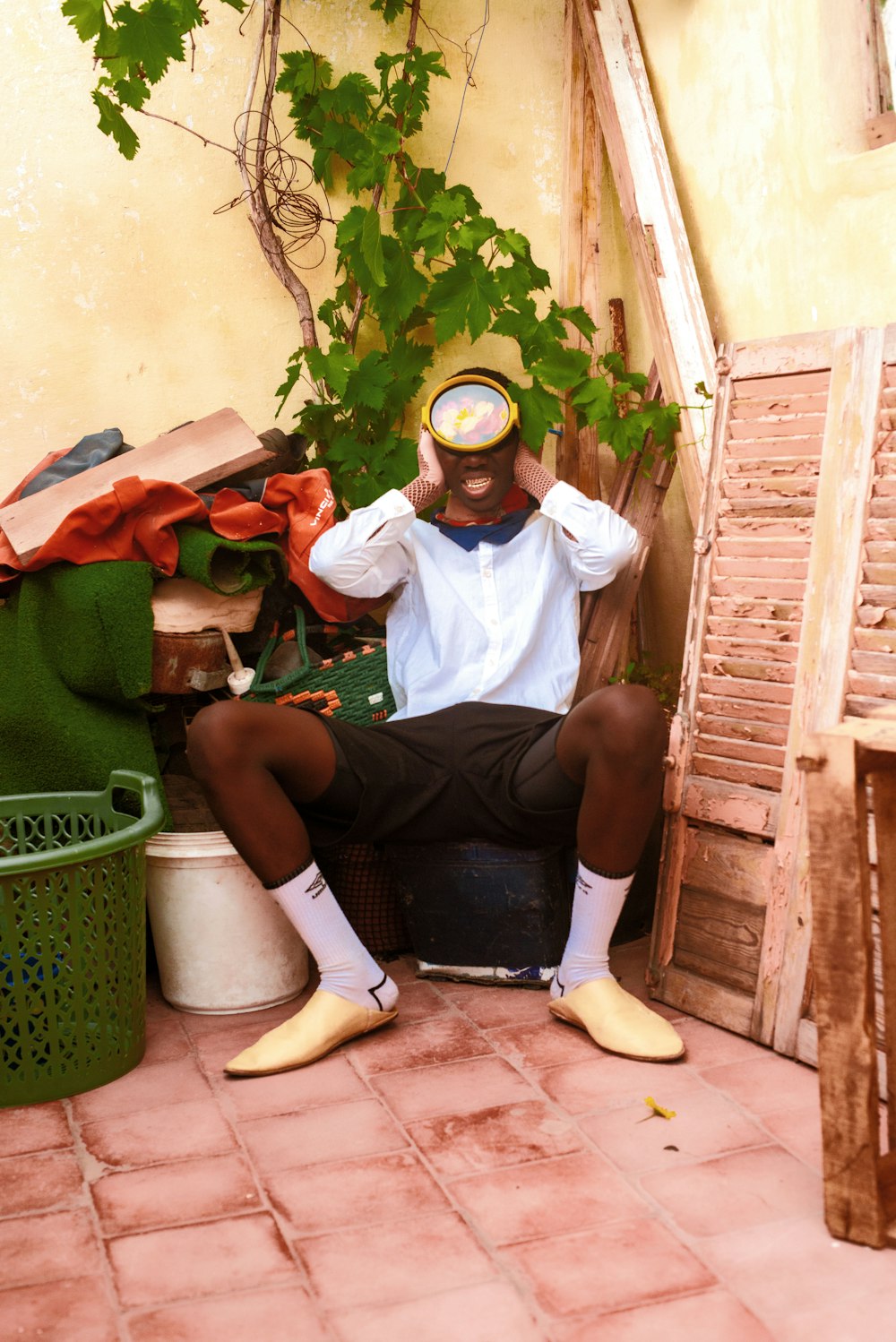 a man sitting on the ground with his head in his hands