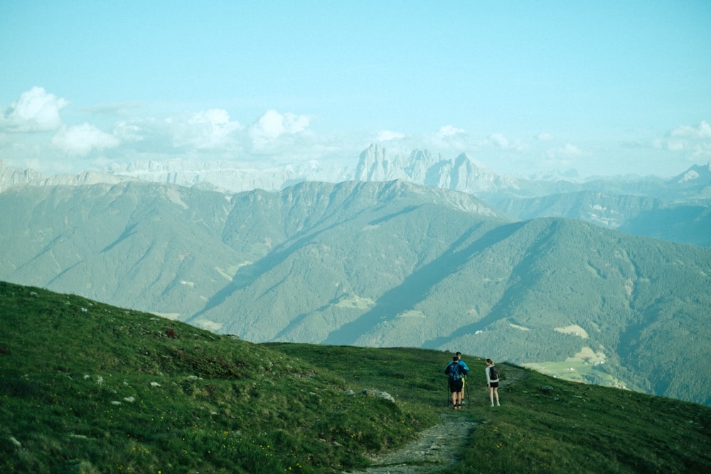 a couple of people that are standing on a hill