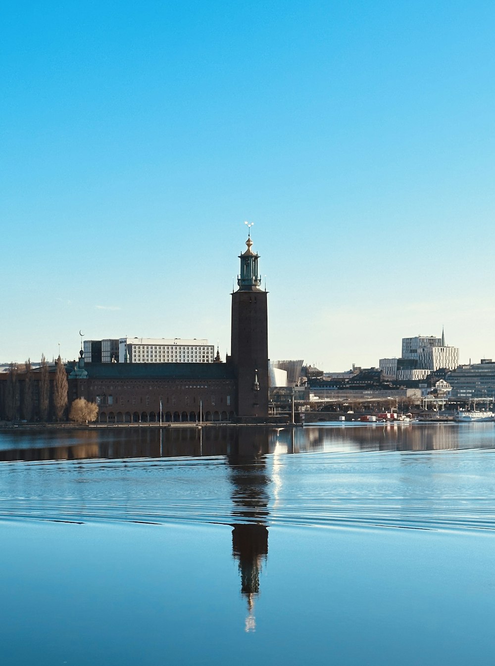 a large body of water with a clock tower in the background