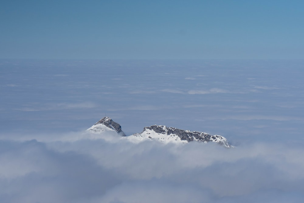 a view of a mountain in the middle of the clouds
