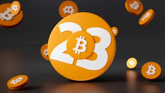 A large orange disc with the number 23 prominently displayed in white, accompanied by the Bitcoin symbol. Smaller orange discs with Bitcoin symbols surround the main disc, all set against a dark background.