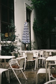 A cheerful outdoor space with freshly cleaned patio furniture and blooming plants.