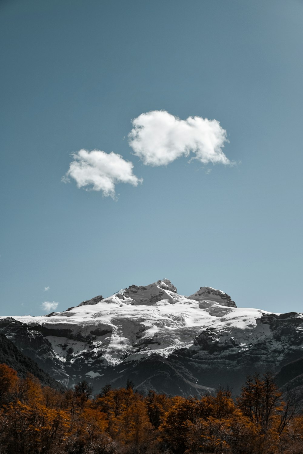 a mountain with a cloud in the sky