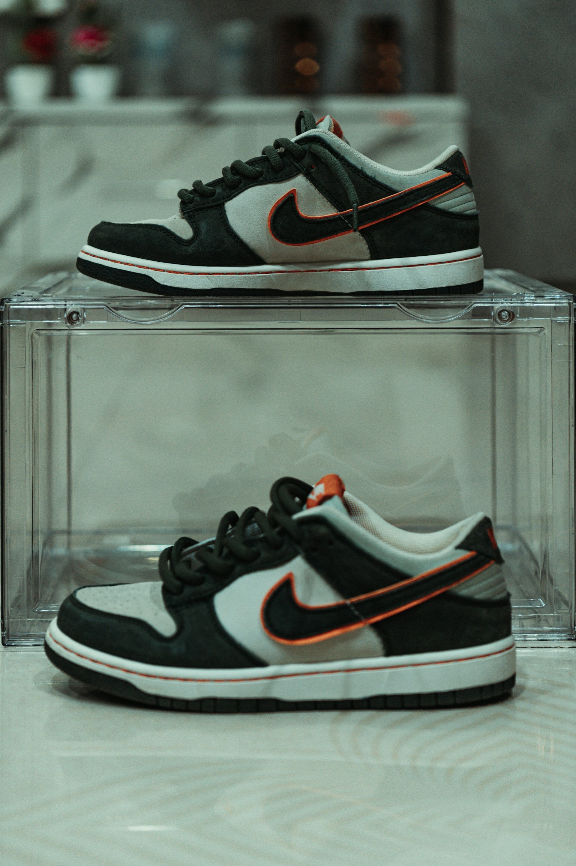 a pair of black and white sneakers on display