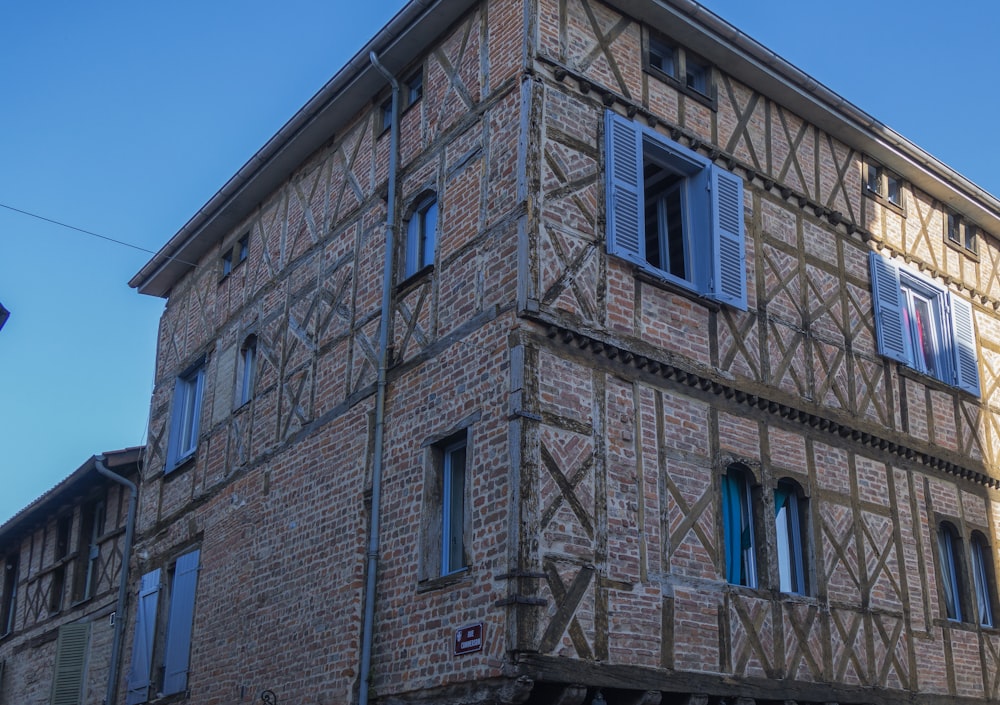 a tall brick building with a clock on the front of it