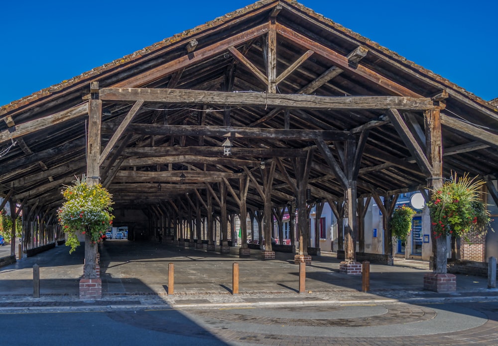 a large wooden structure sitting on the side of a road