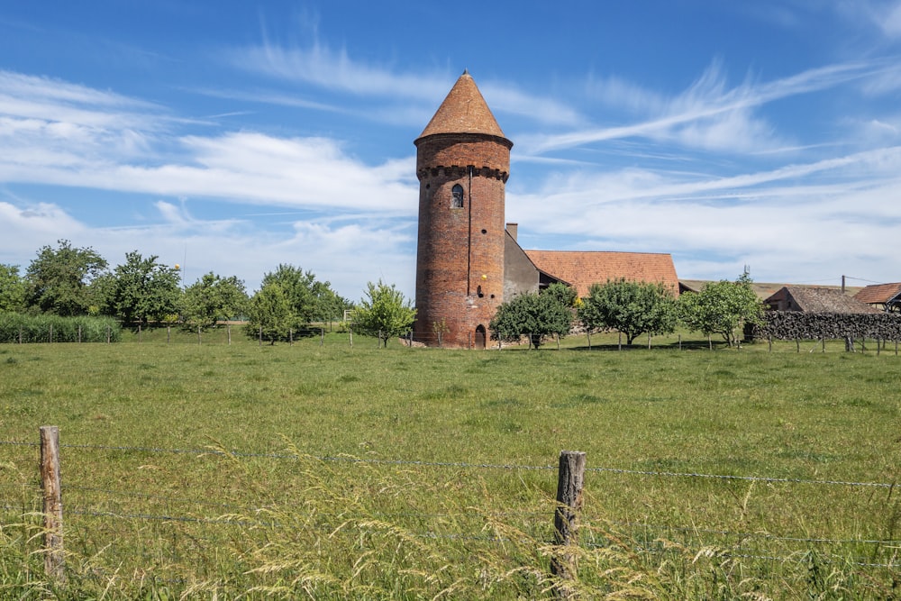 a large brick building sitting on top of a lush green field