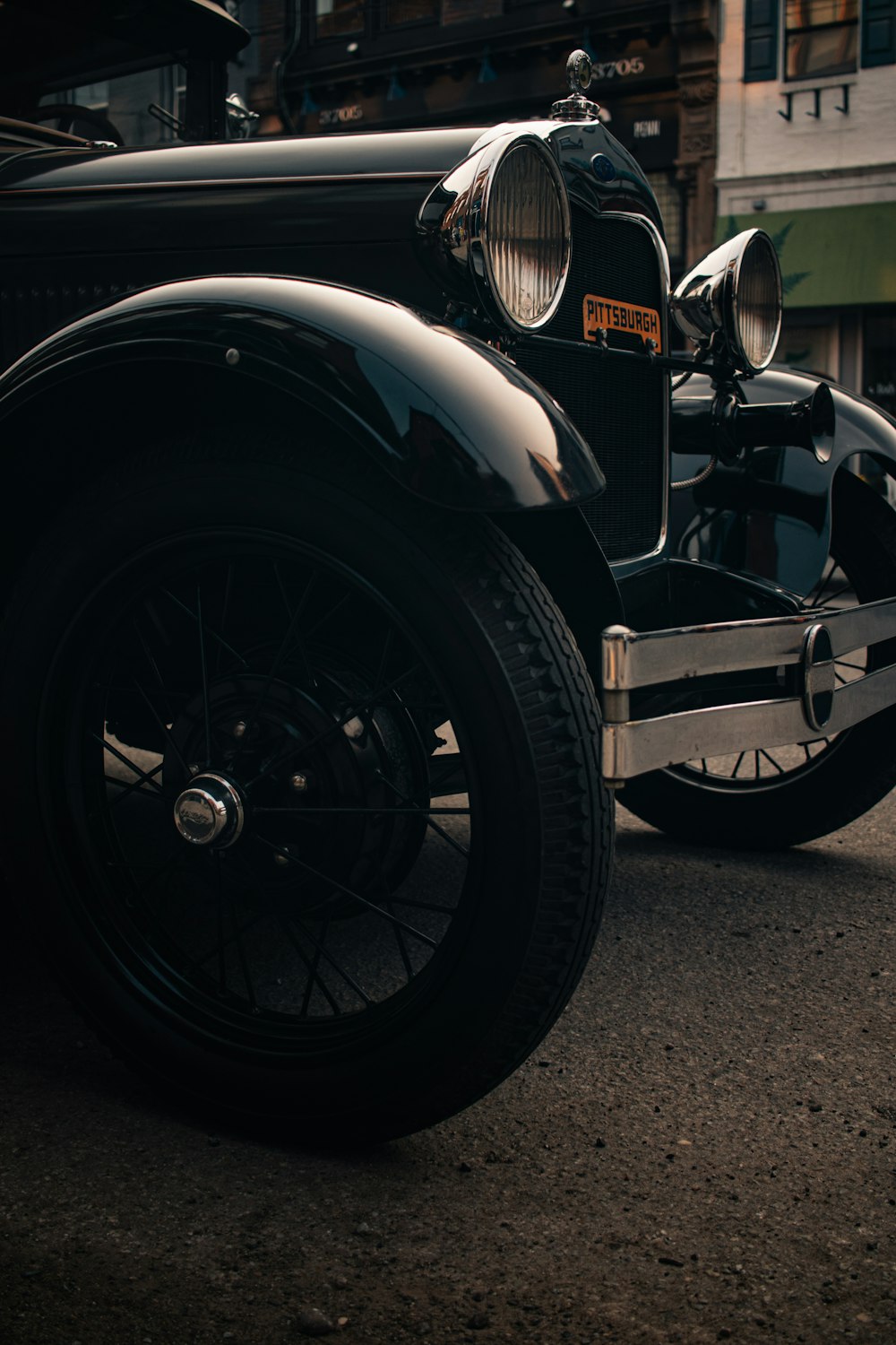 a vintage car parked on the side of the road