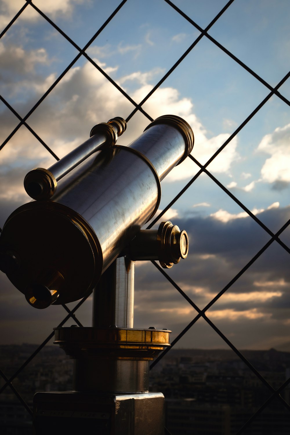 a telescope sitting on top of a metal pole