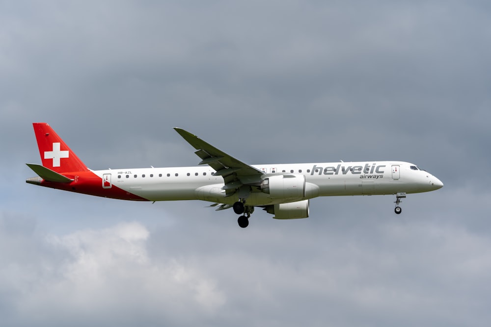 a large passenger jet flying through a cloudy sky