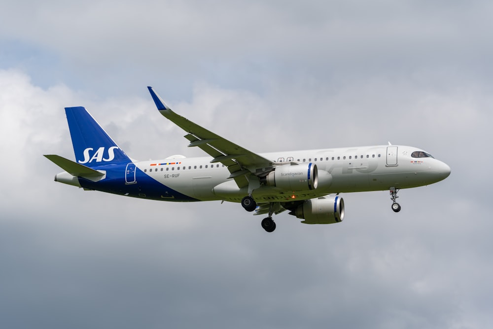 a large jetliner flying through a cloudy sky