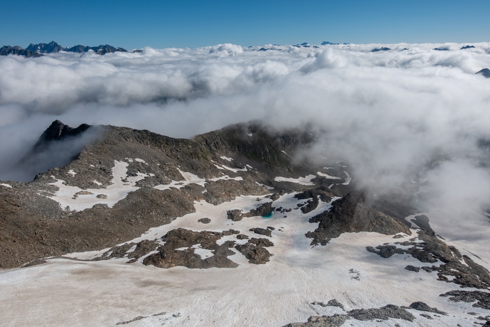 a snow covered mountain with a few clouds