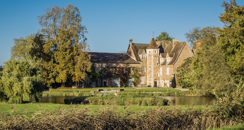 a large house with a pond in front of it