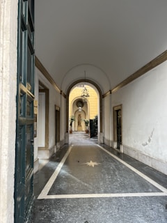 Elegant hallway with white walls, navy blue trim, and sandy gold decorative elements