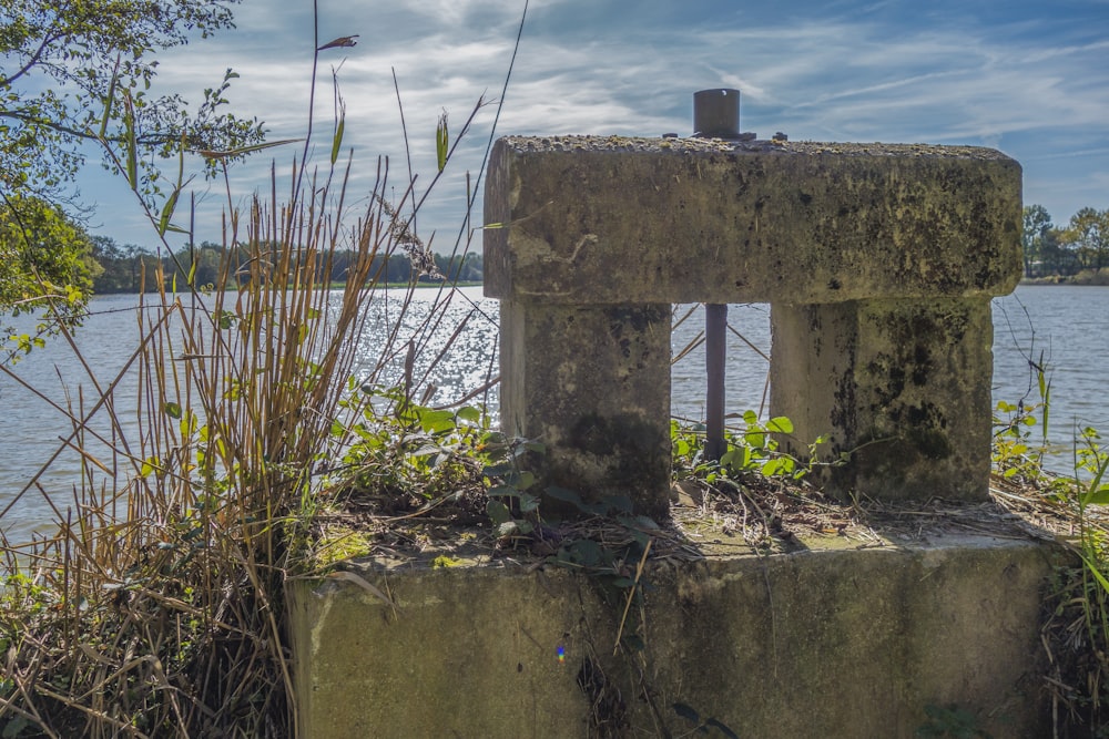 a concrete structure sitting on top of a lush green field