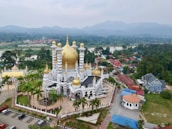 An aerial shot of Abu Dhabi's iconic landmarks, including the Sheikh Zayed Grand Mosque and the Emirates Palace.