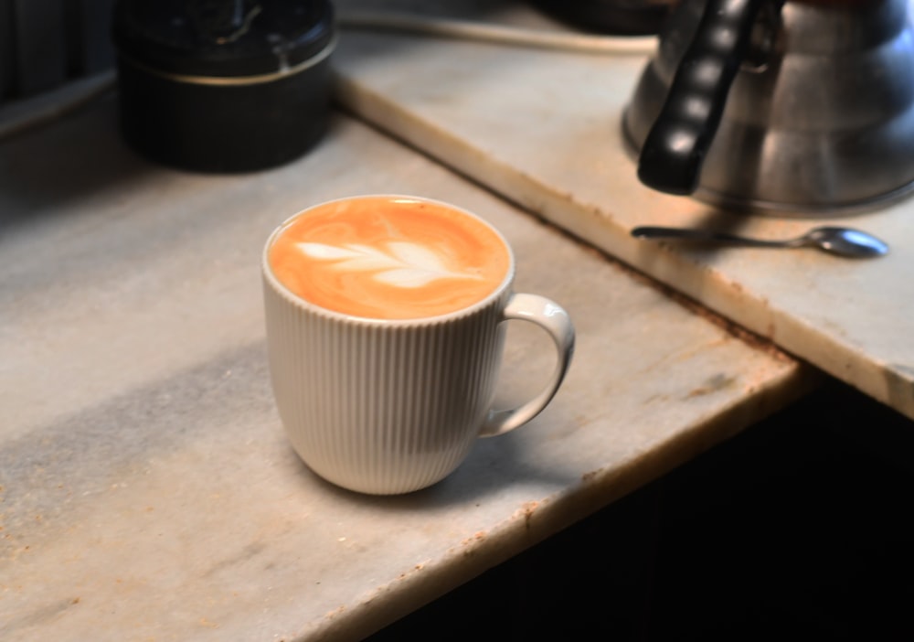 a cup of coffee sitting on top of a counter