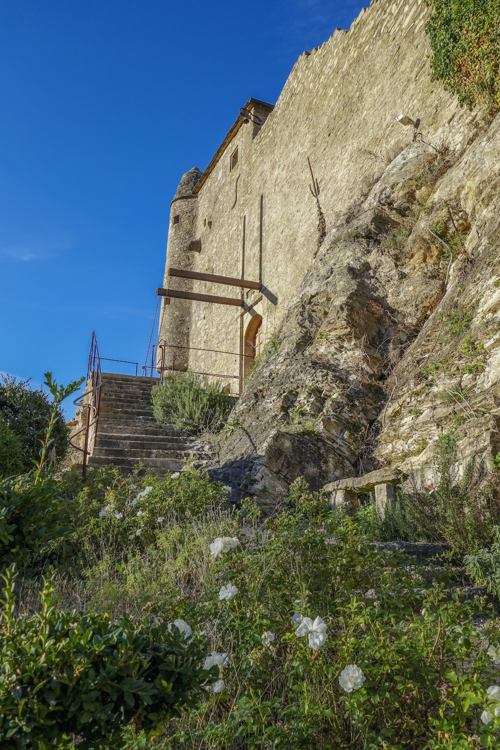 a stone building with a staircase going up the side of it