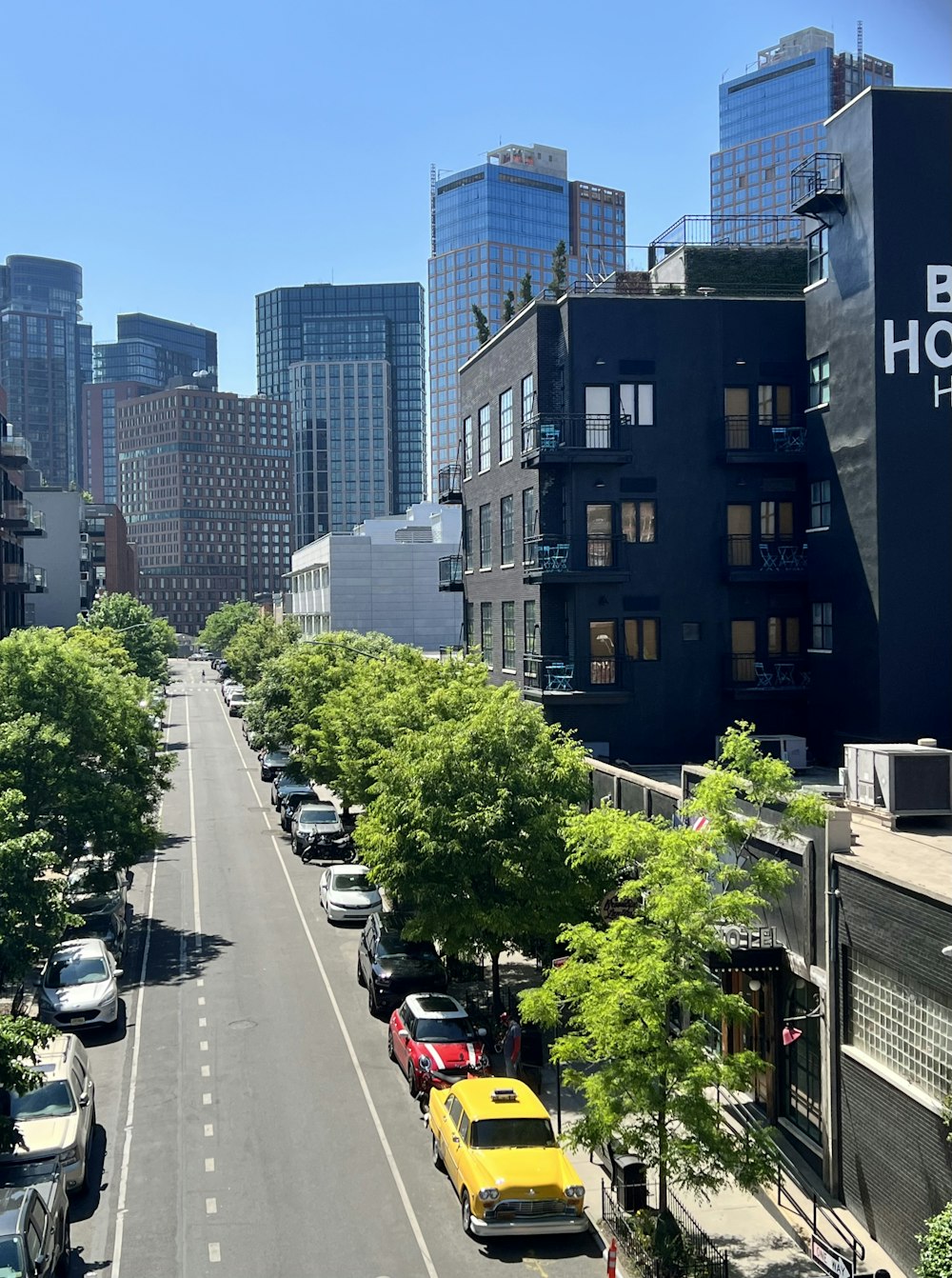 a city street lined with tall buildings and trees