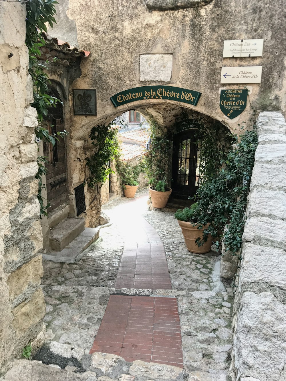 a stone building with a walkway going through it