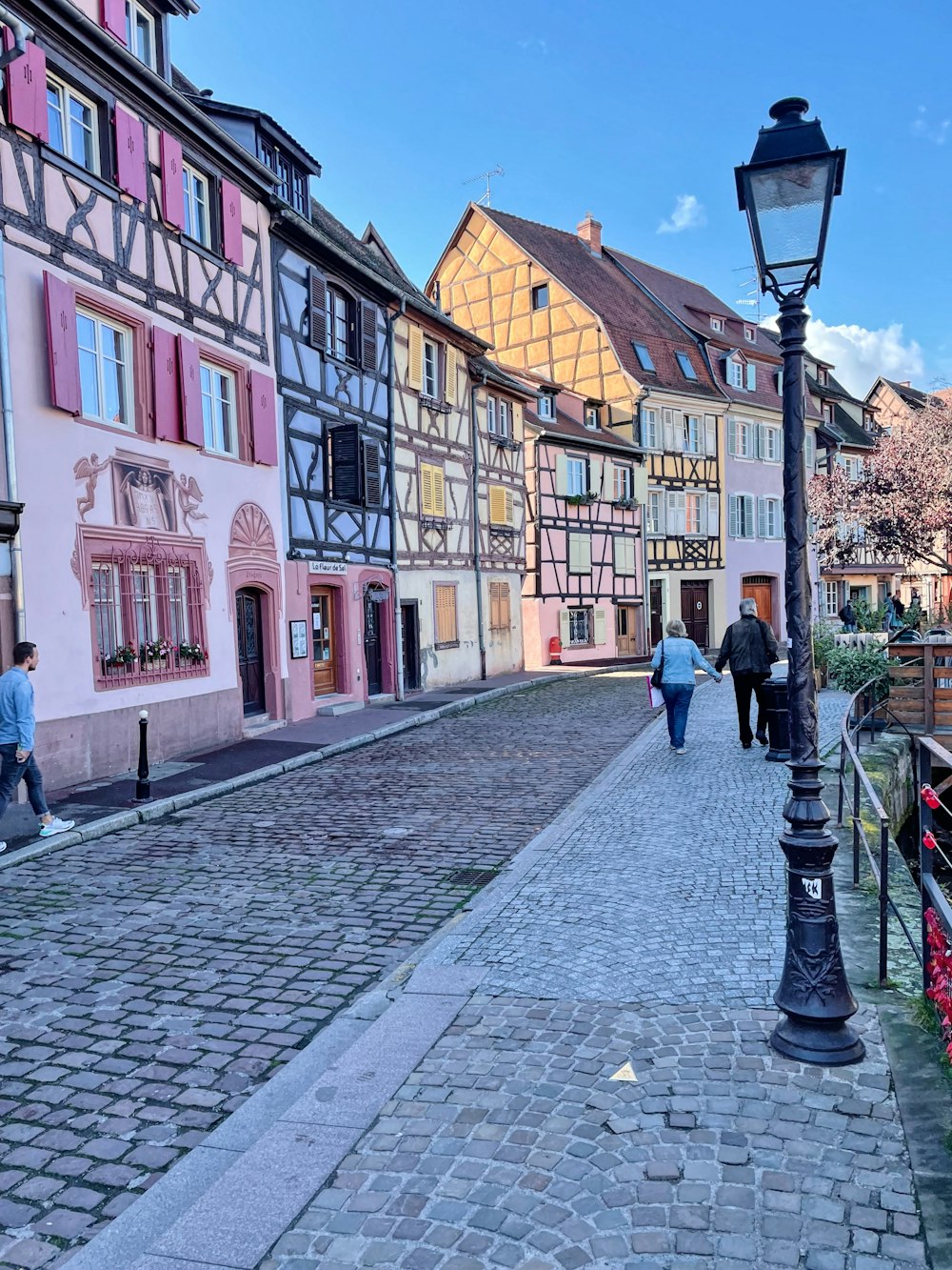 a cobblestone street lined with colorful buildings