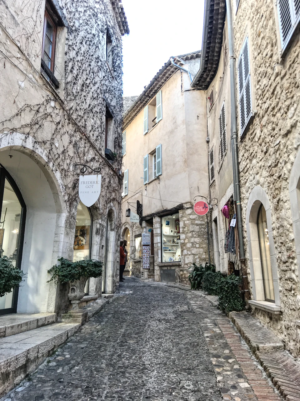 Narrow cobblestone street lined with medieval limestone buildings in Saint-Émilion