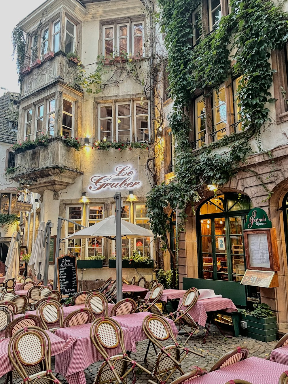 a restaurant with tables and chairs outside of it