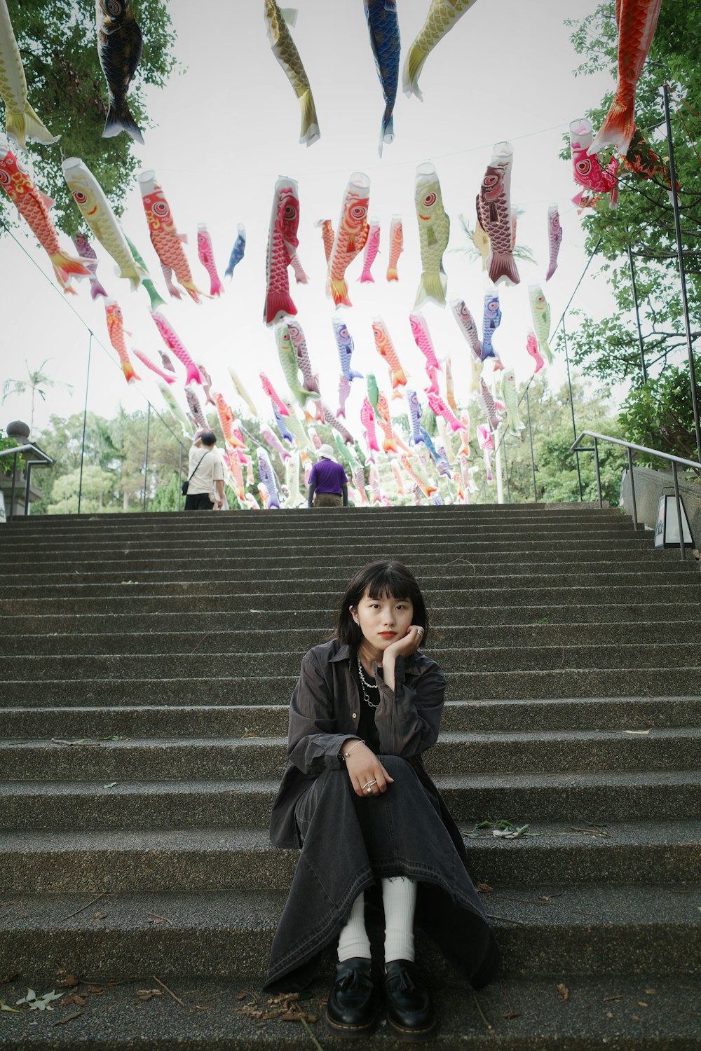 a woman sitting on a set of stairs