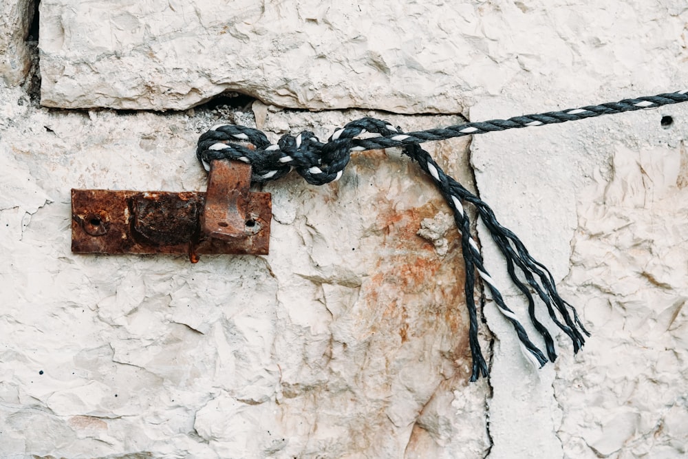 a rusted padlock attached to a stone wall