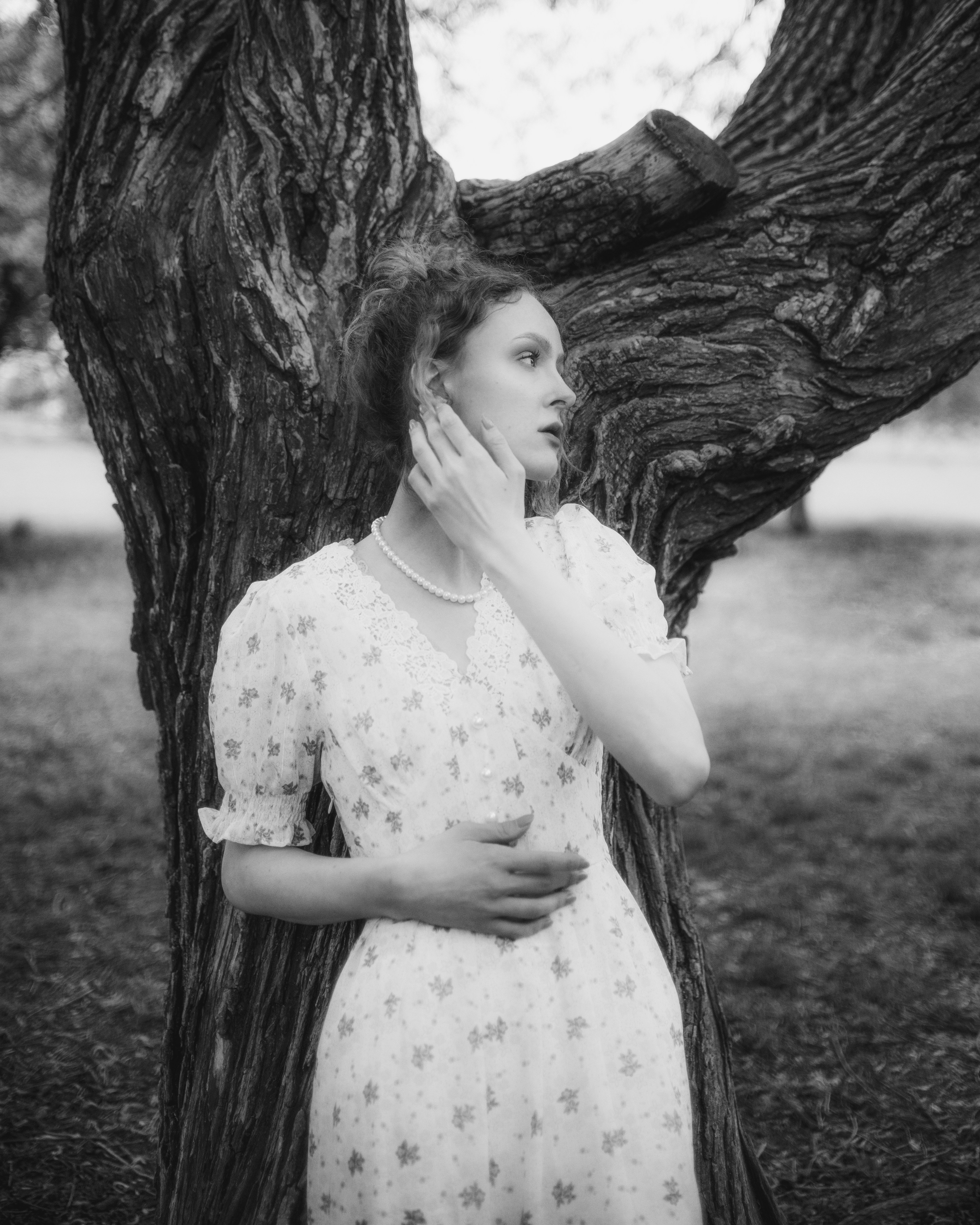 A woman in a dress standing next to a tree photo – Free Dress Image on ...