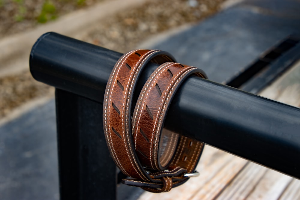 a close up of a leather belt on a bench