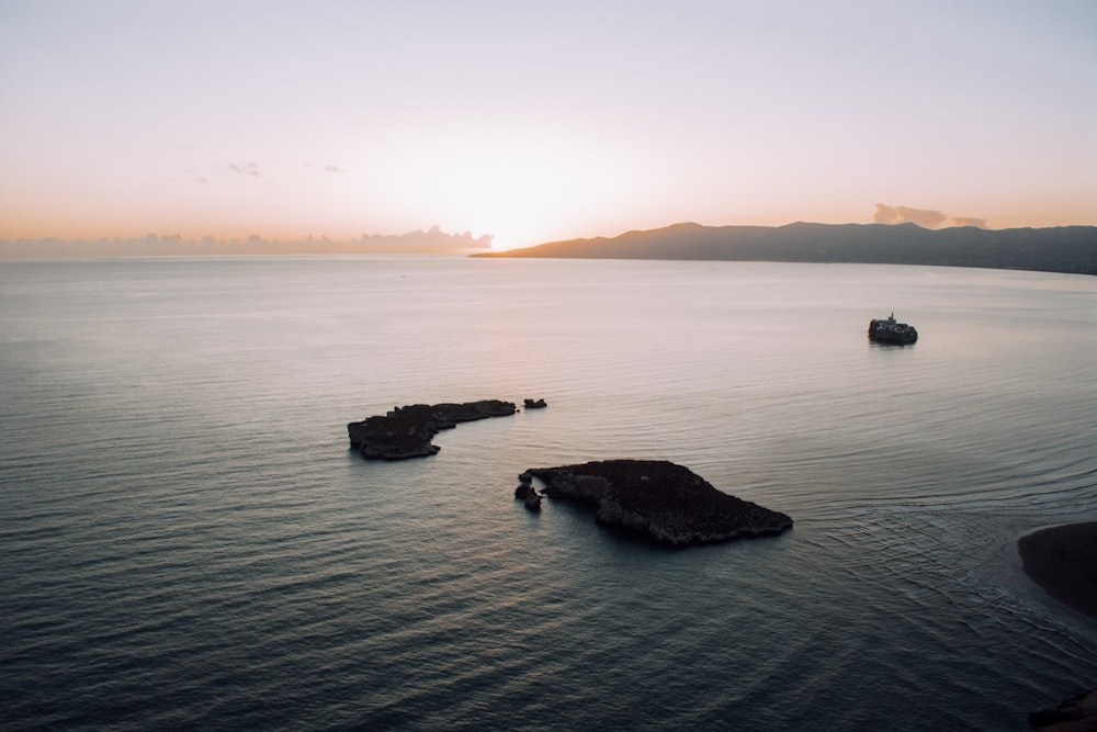 a group of boats floating on top of a large body of water