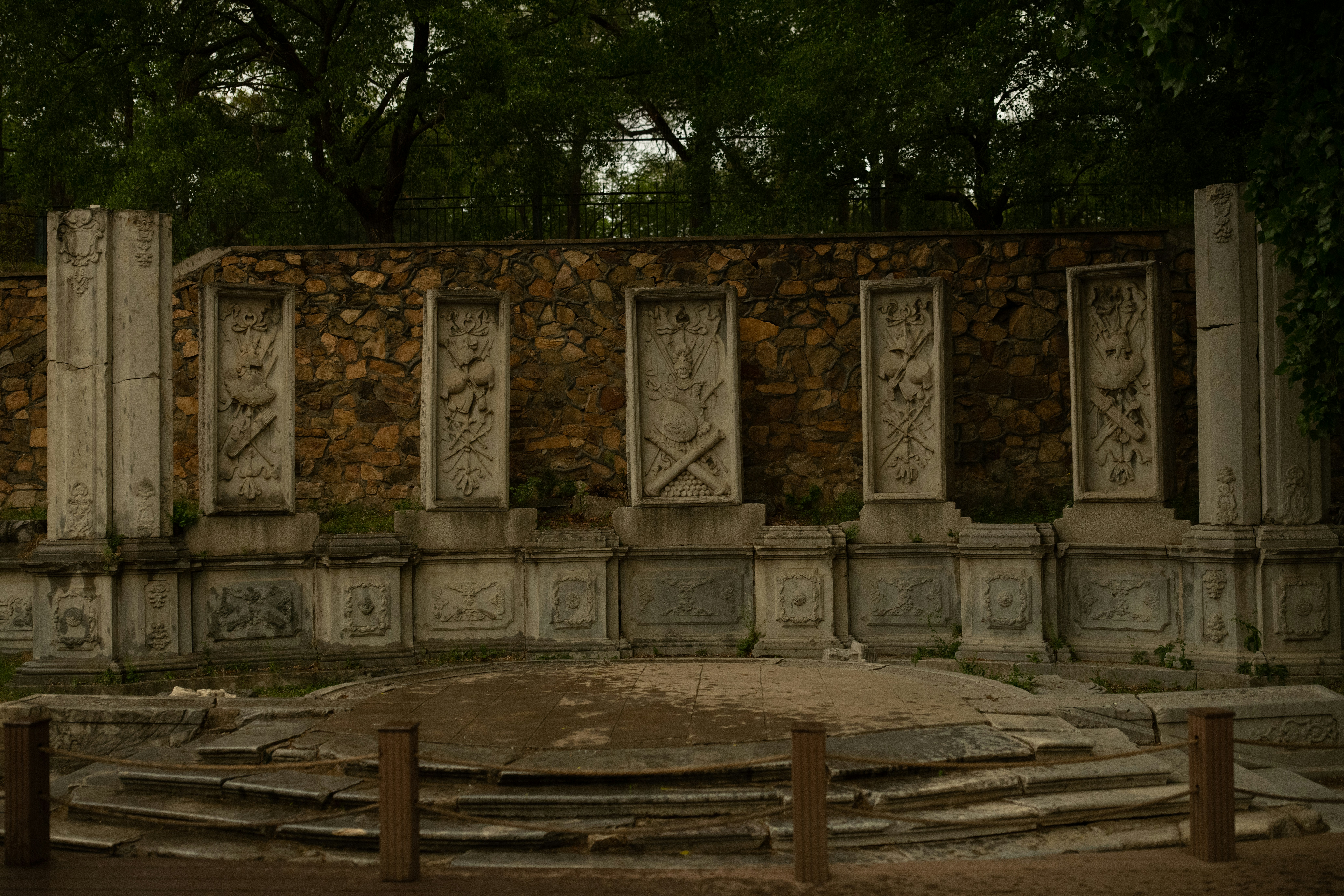 a large stone structure with a wooden fence around it